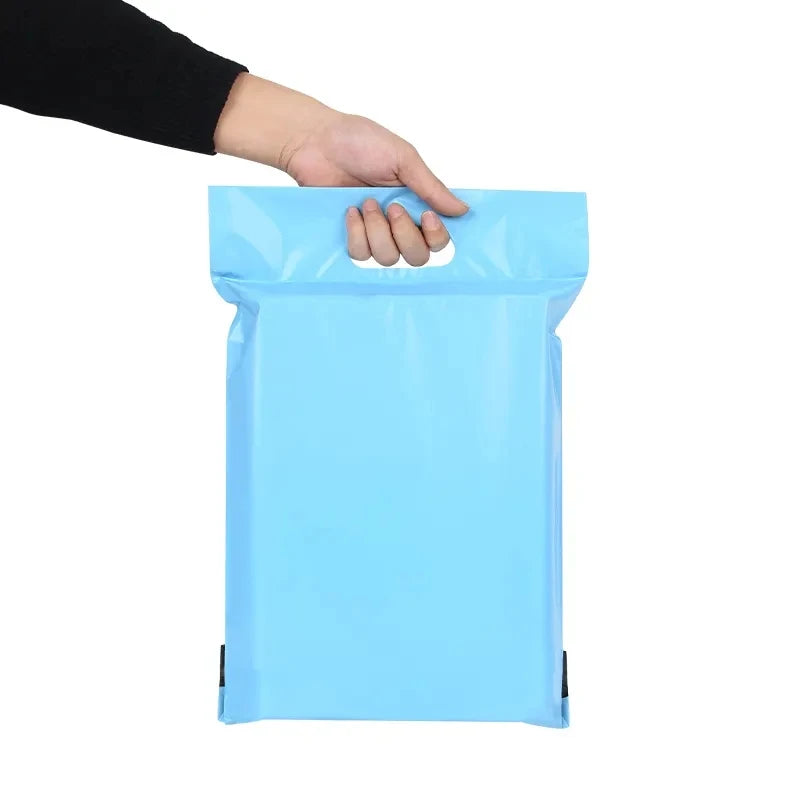Matte light-blue poly mailer bag with handle, gripped by hand