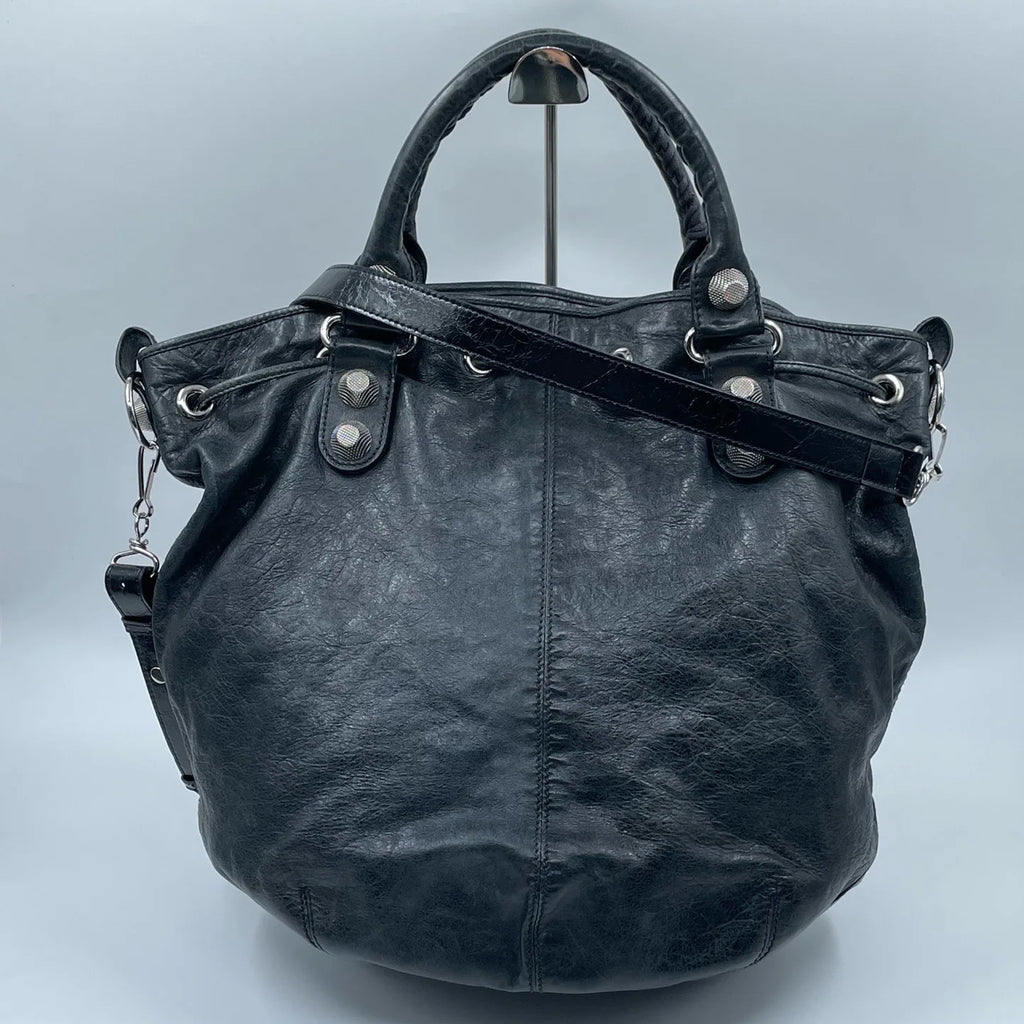 Luxury Pre-Owned Designer Leather Bucket Bag with Chic Metal Studs and Adjustable Shoulder Strap