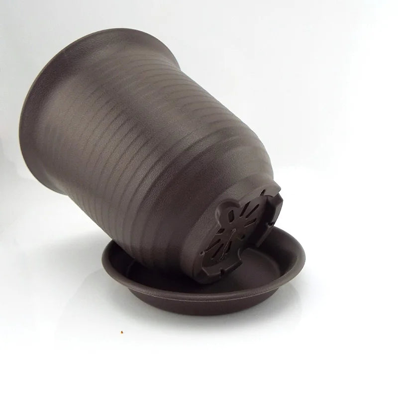 Dark gray plastic flower pot with saucer and underside vented drainage insert.