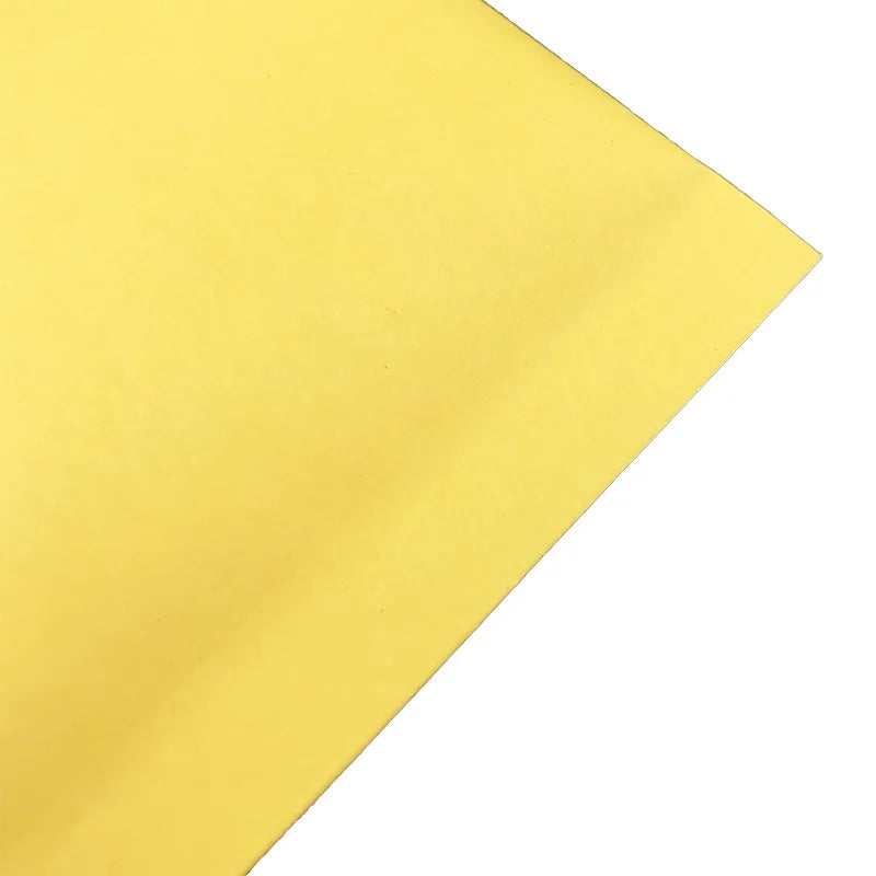 Yellow poly padded mailer corner, smooth surface with sharp fold