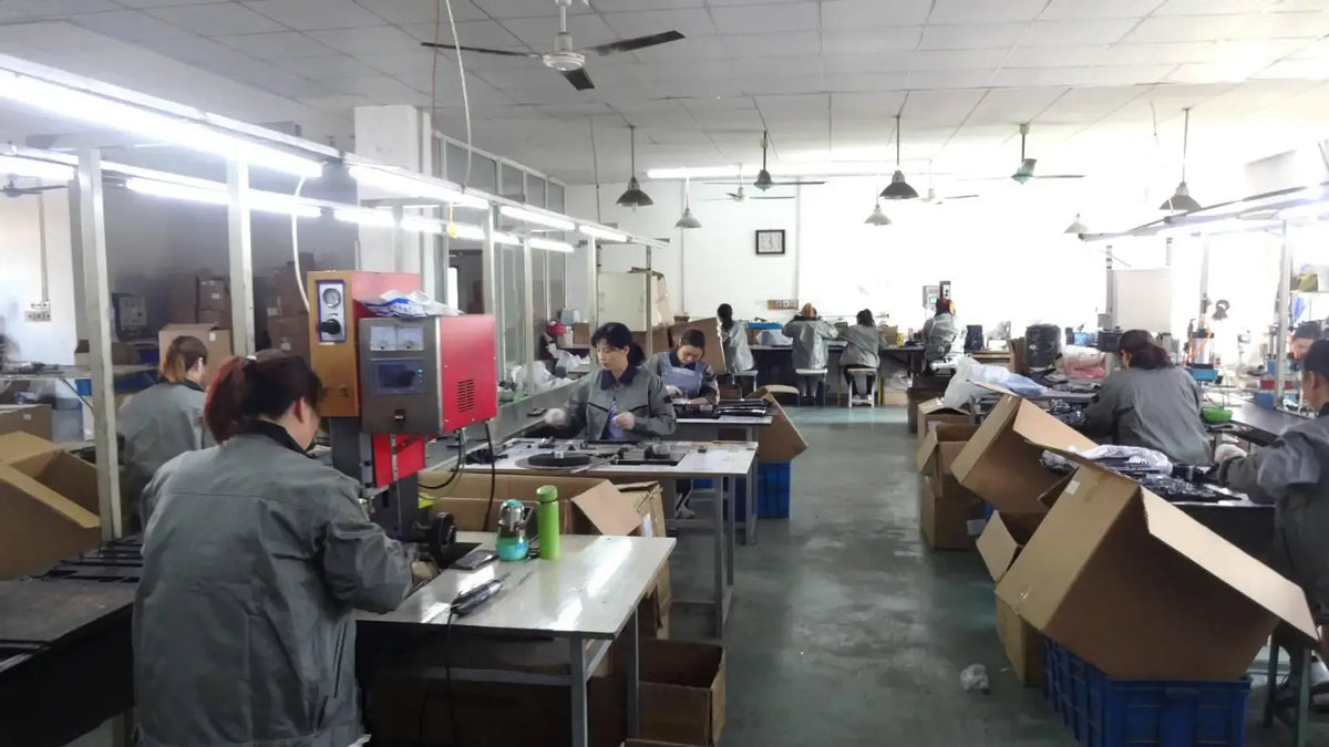 Label printer assembly line with multiple workbenches and cassette units in production.
