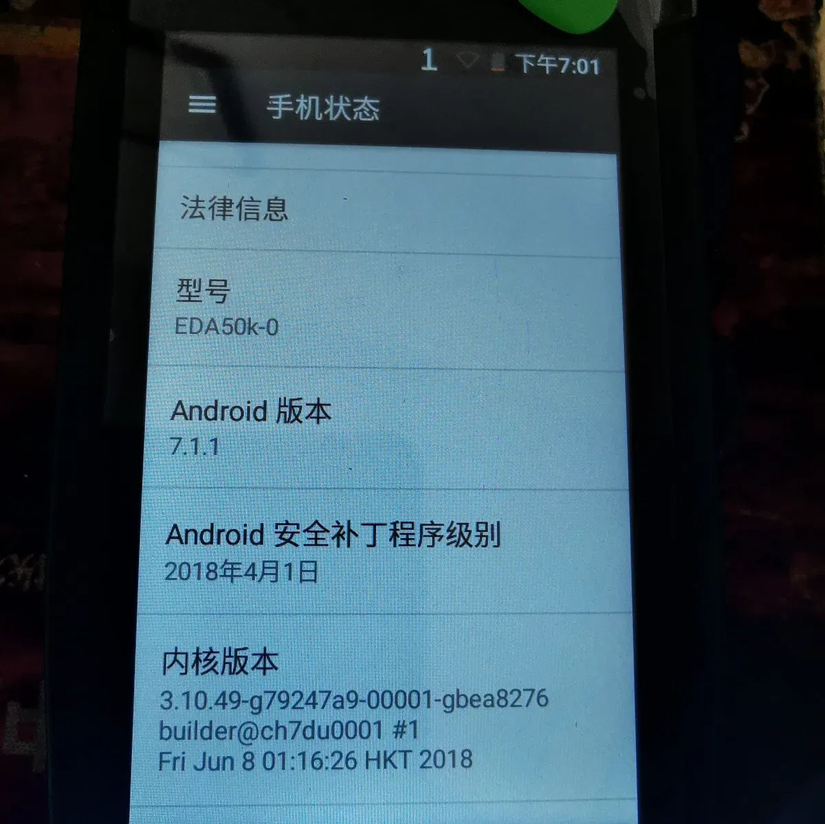 Honeywell touchscreen close-up showing device info screen with Android version