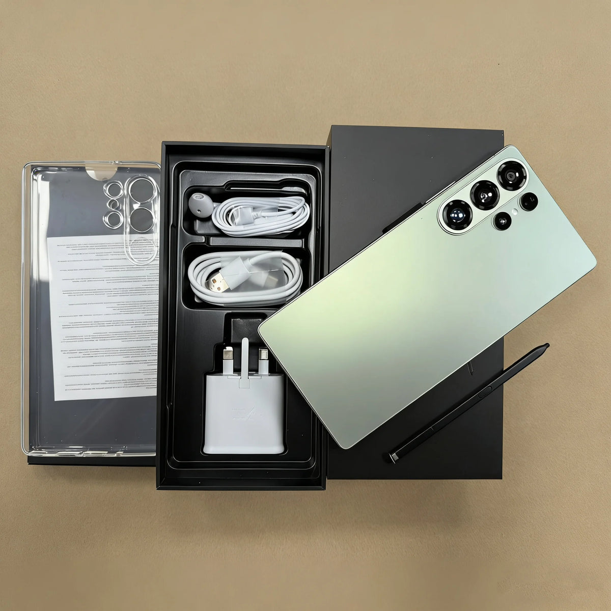 Smartphone with mint back, open box showing charger, cables, and S Pen stylus