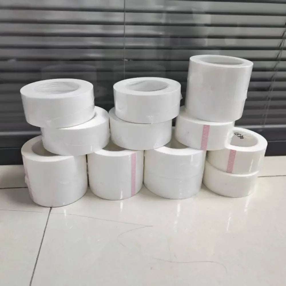 Stack of white PE shrink wrap tape rolls, ready for construction repair
