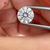 Round brilliant-cut lab-grown diamond held in tweezers