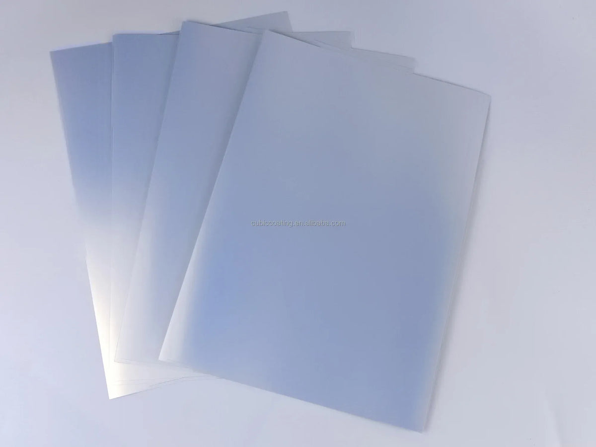 Silver-toned printable sticker vinyl sheets stacked, matte finish, ready for use.