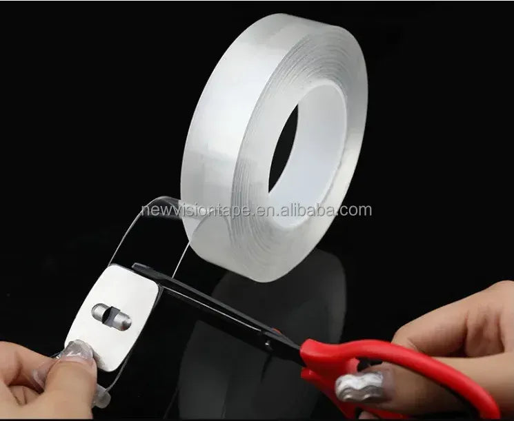 White double-sided nano tape roll with backing, being cut and applied by hands