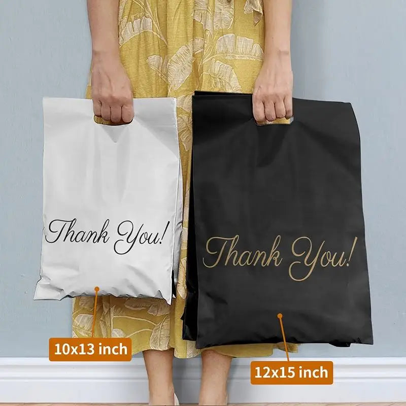 Two handle mailer bags: white and black, each printed 'Thank You!'