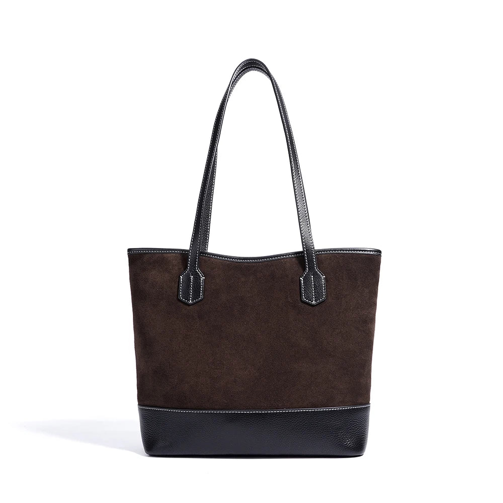 Dark brown suede underarm tote bag with black textured leather base, minimalist vintage style, and stitched handles.