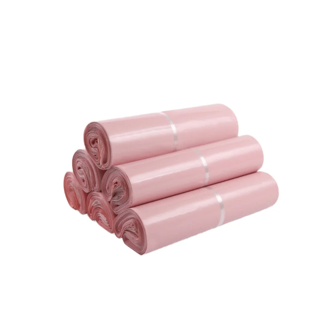 Rolled plastic mailing bags, pink, tightly stacked