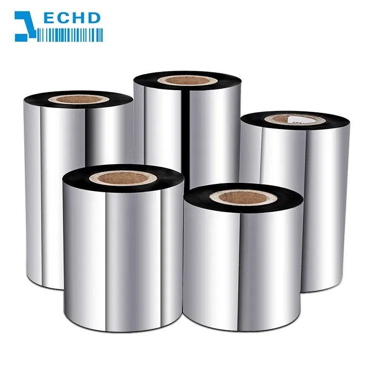 Stack of wax/resin barcode ribbon rolls, silver film with black edges and brown spool centers