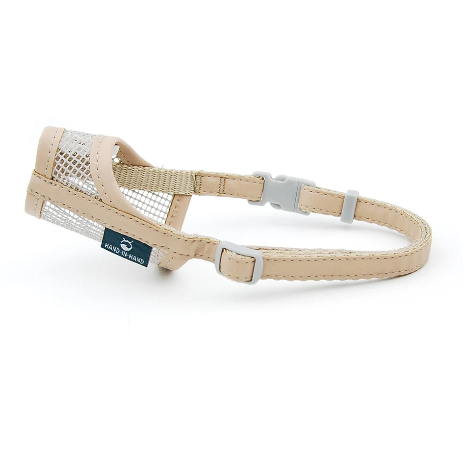 Beige mesh and leatherette dog muzzle for safe, breathable training. Adjustable strap for small to large dogs.