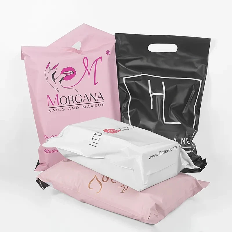 Stacked pink and black poly mailer bags with handle, brand logo prints visible.