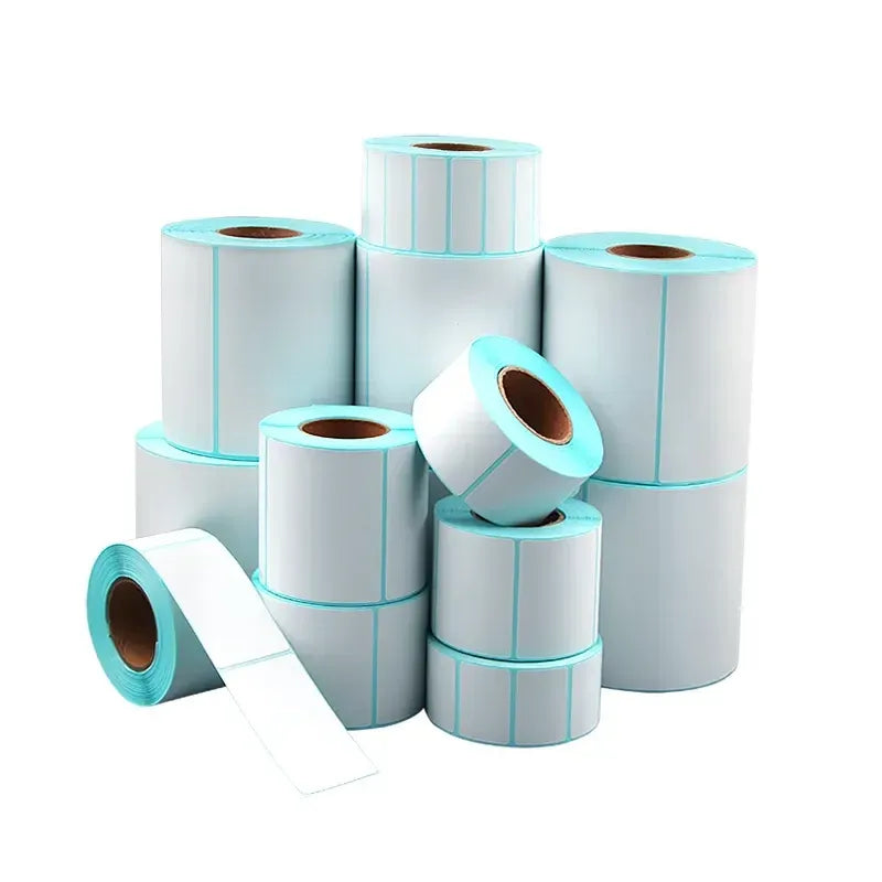Stack of sky blue direct thermal label rolls on a paper backing, blank label sheets