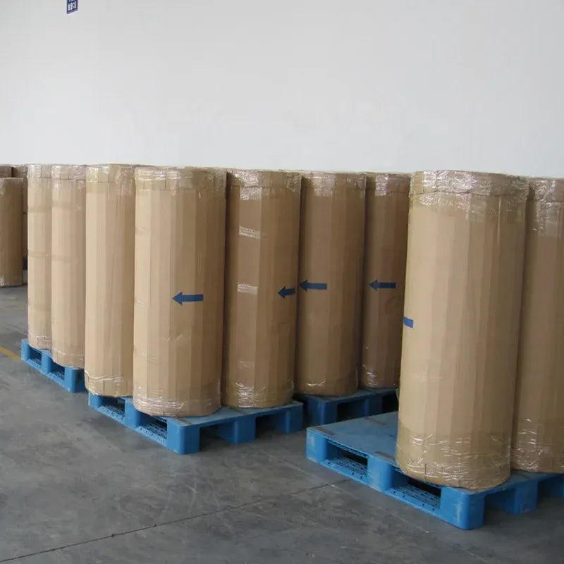 Clear BOPP tape jumbo rolls stacked on blue pallets in storage room