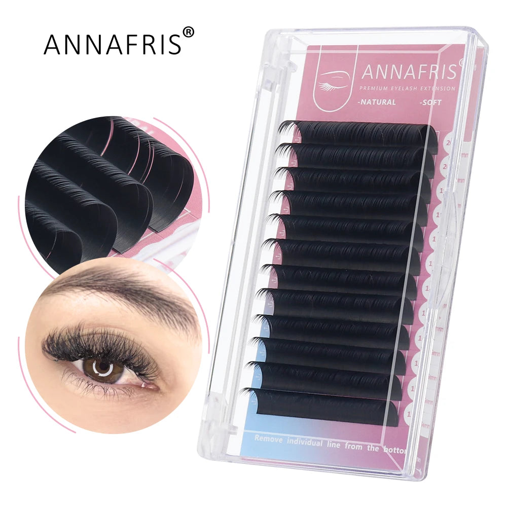 Black synthetic eyelash extension strips in a clear plastic storage case for professional lash application.