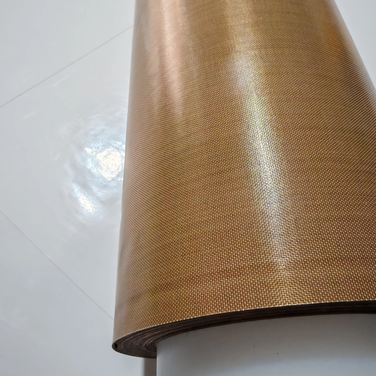 Close-up of brown PTFE tape roll surface with fine woven texture