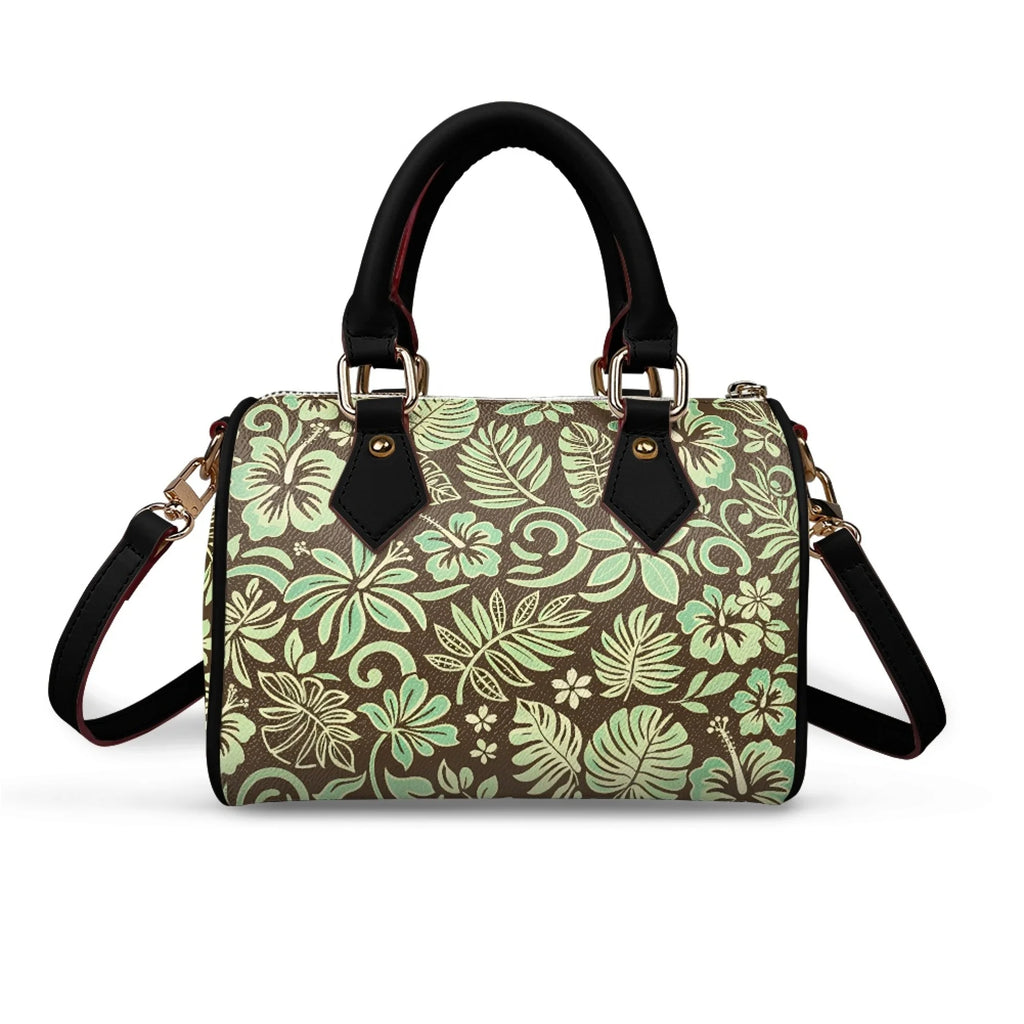 Pillow-shaped handbag with brown and mint green tropical floral print, black handles, and gold hardware. Trunk style.