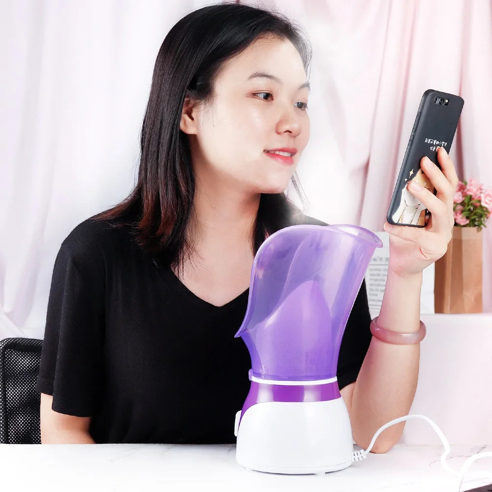 Woman using a purple and white facial steamer for deep pore cleansing and skin moisturizing at home.