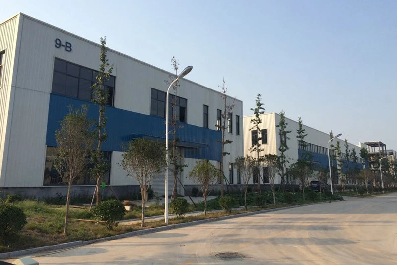 Shipping mailer production facility exterior building with landscaped grounds