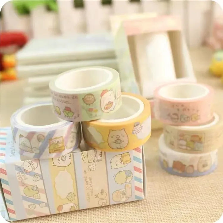 Stacked washi tape rolls with cute character designs in pastel colors