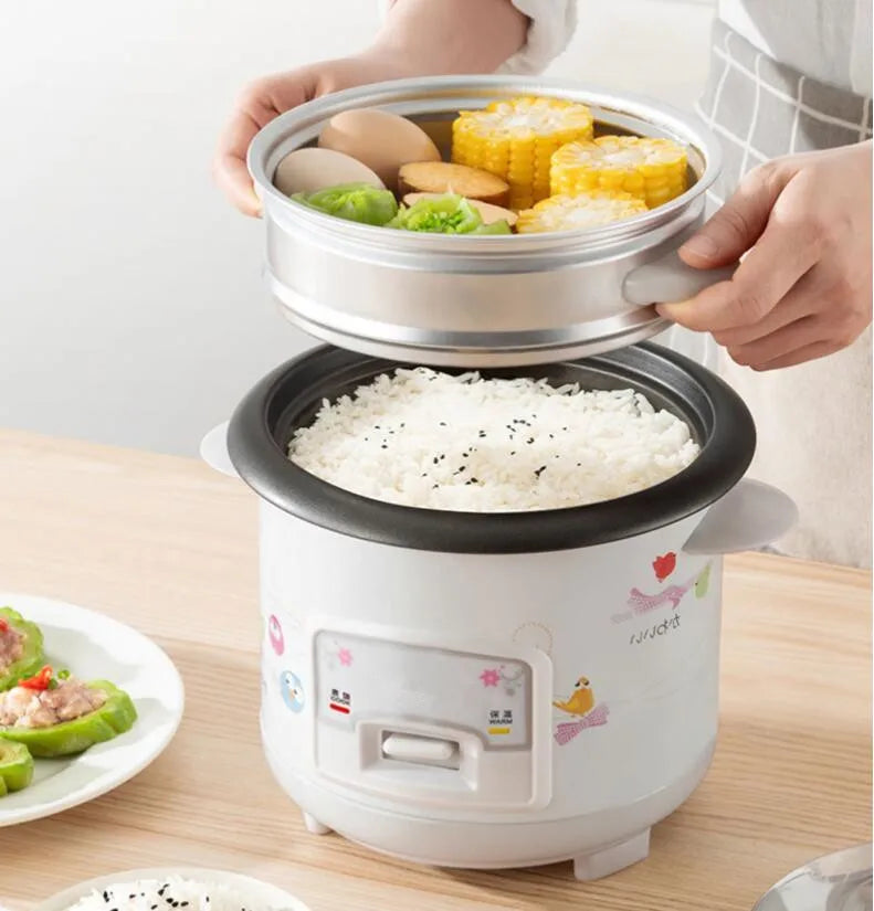 Mini electric rice cooker with transparent lid and food steaming basket insert, white body