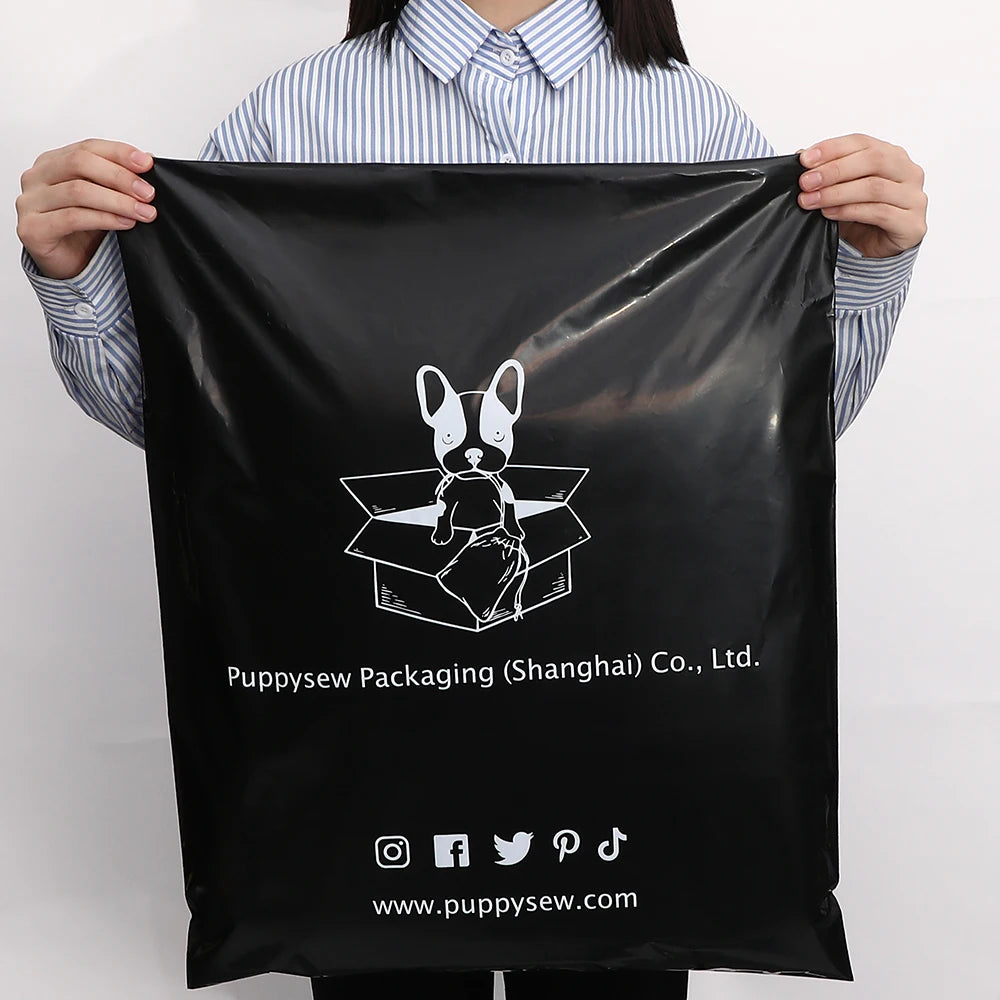 Black poly mailer held up, showing large bunny logo and brand website print