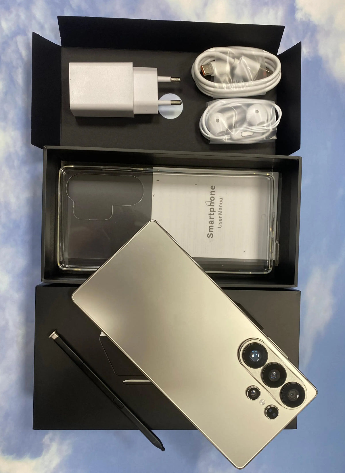 S26 Ultra phone in gold with triple rear cameras, inside open retail box.