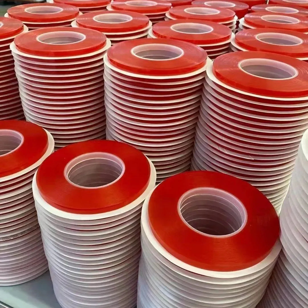 Stacked red double-sided polyester tape rolls with exposed circular inner openings