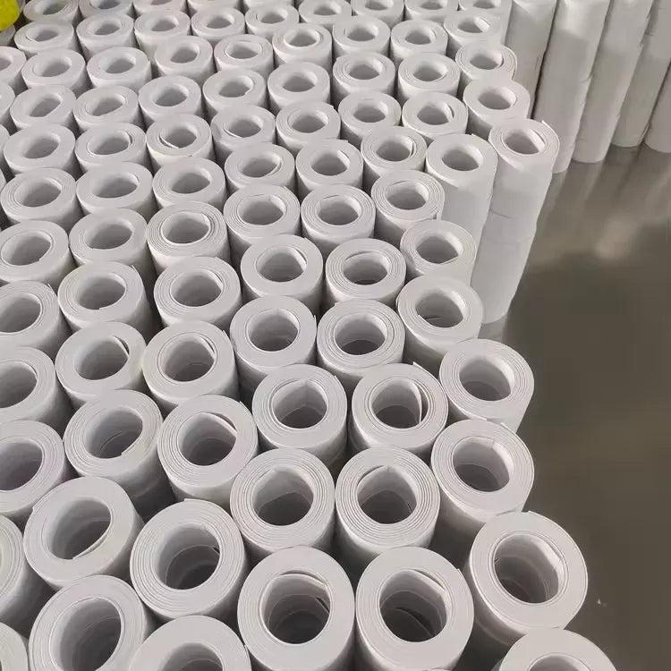 White self-adhesive PVC caulk tape rolls stacked for bathroom sealing