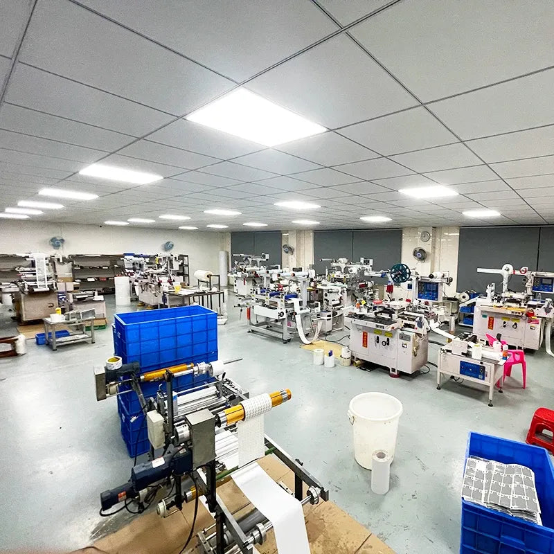 Industrial workshop room with rows of sewing and assembly machines