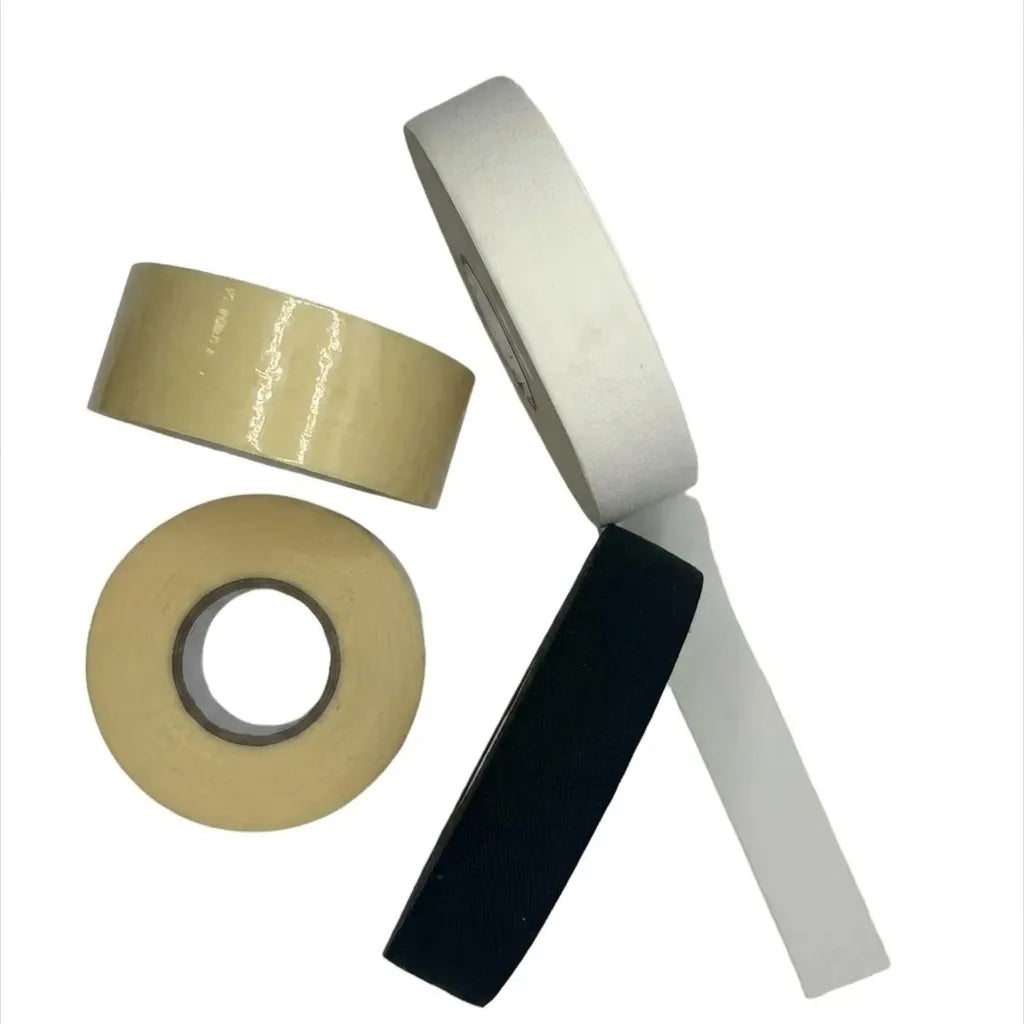 Field hockey grip tape set with gold and gray rolls and a black strip