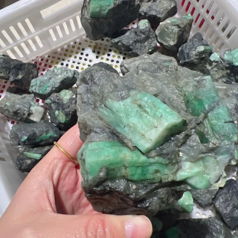 Rough green crystal quartz chunk with translucent mint crystal veins on dark gray rock