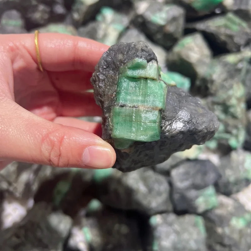 Small rough green crystal quartz fragment with mint-green crystal blocks on dark base