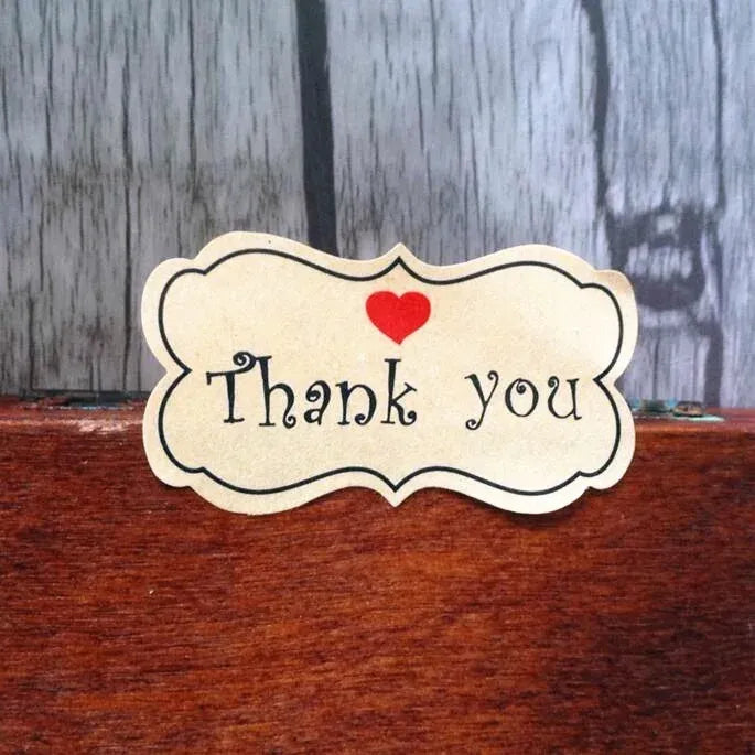 Flower-shaped kraft Thank you label sticker with red heart at the top center
