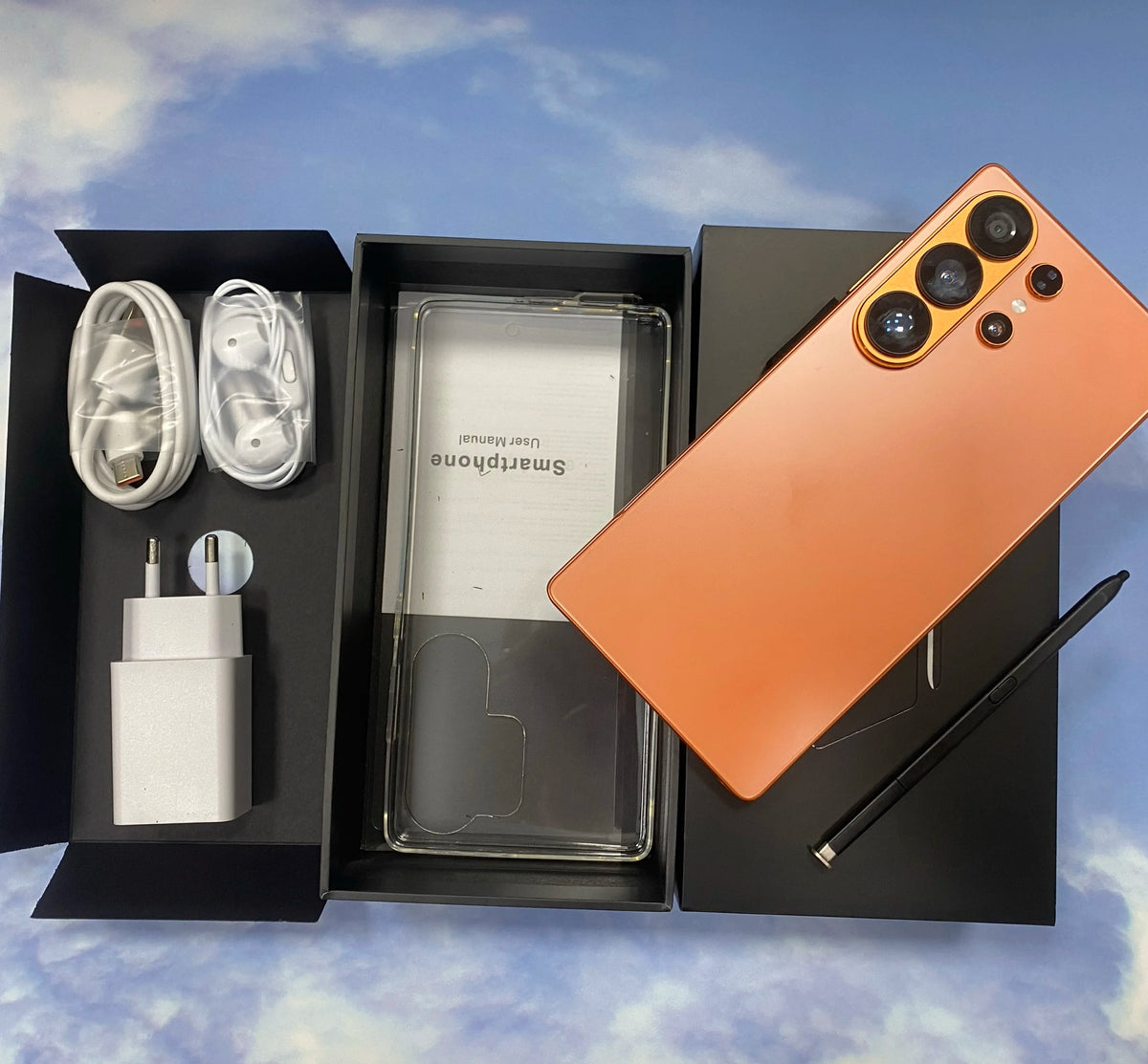 Orange smartphone back with quad cameras and matte finish, shown with protective covers