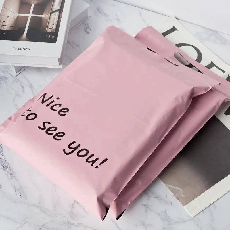 Pink poly mailer shipping bag with handle and “Nice to see you!” text