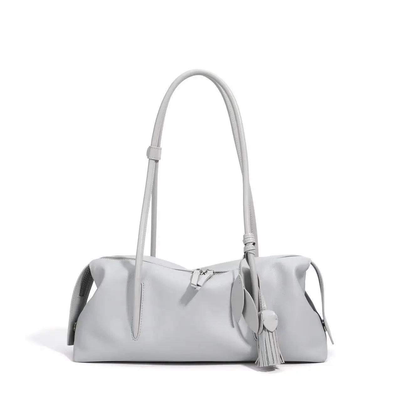 Light gray genuine leather trunk shoulder bag with tassel charm, top zipper closure, and soft cowhide construction.