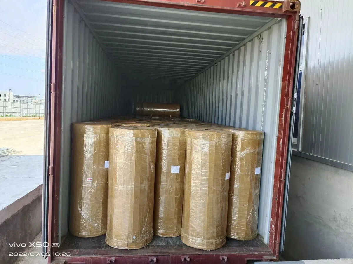 BOPP adhesive tape jumbo rolls, packed in an open shipping container