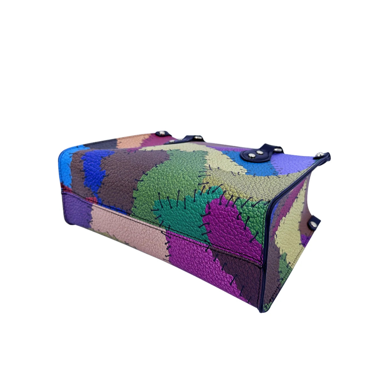Multicolor patchwork PU leather travel trunk handbag with visible black stitching and metal rivet accents.