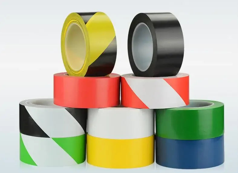 Multicolor packaging tape rolls on cores: yellow, black, white, green, blue