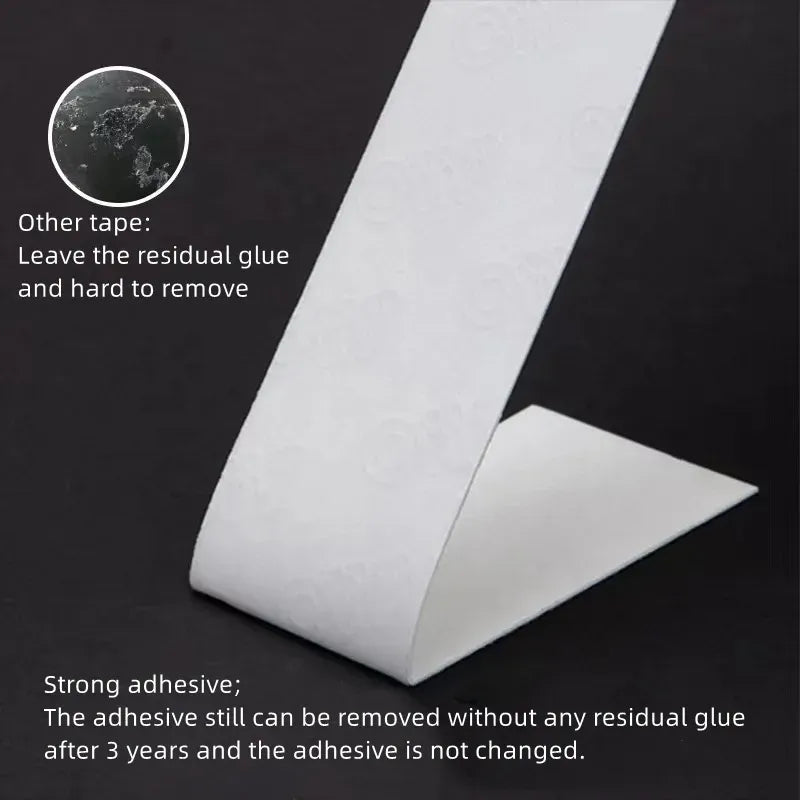White double-sided foam tape strip folded into a V shape for mounting