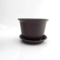 Dark gray plastic plant pot with saucer, centered view showing rim and base.