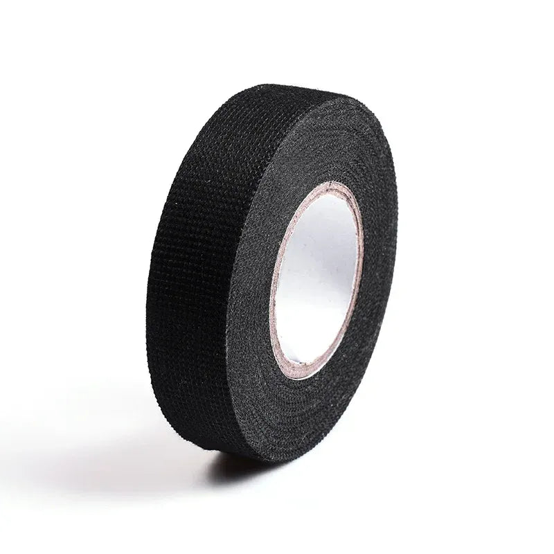 Single black fabric insulation tape roll showing roll edge and inner core