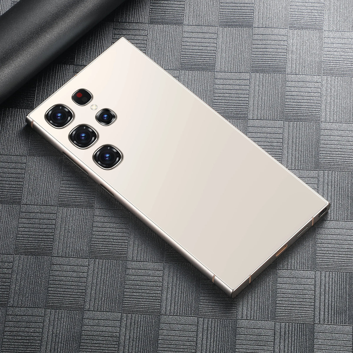Cream smartphone back with quad rear cameras on a gray textured surface