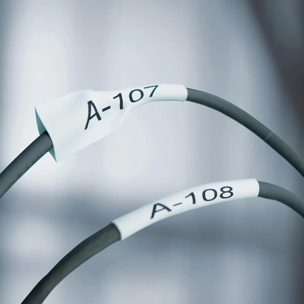Heat-shrink cable labels, white sleeves on gray wires, marked A-107 and A-108