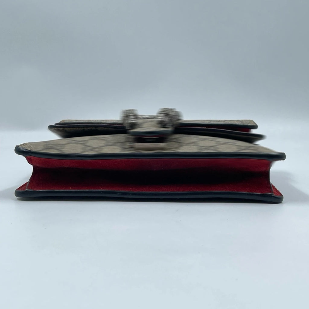 Pre-owned designer shoulder bag, beige canvas with vintage monogram pattern, tiger head closure, red interior lining.