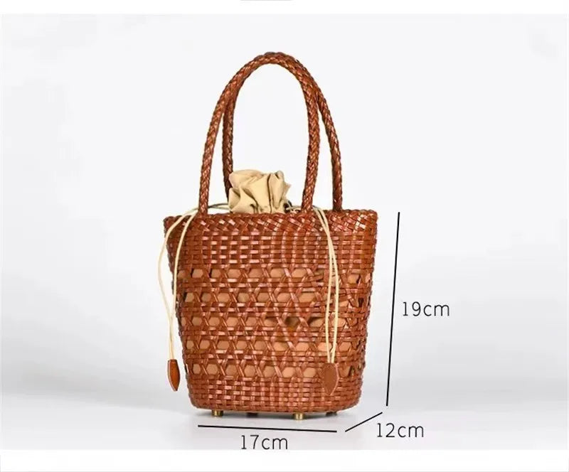 Brown handwoven leather bucket bag with cross-weave cannage design and drawstring beige inner pouch. Trunk style bag.