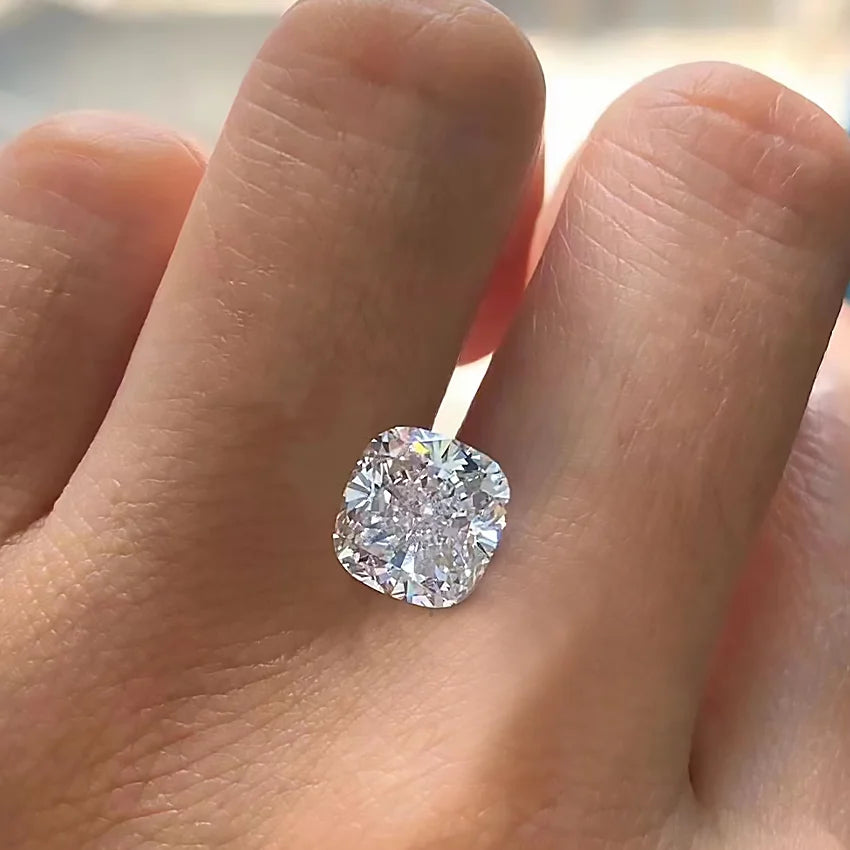Cushion-cut lab diamond in white tone, set on fingertip