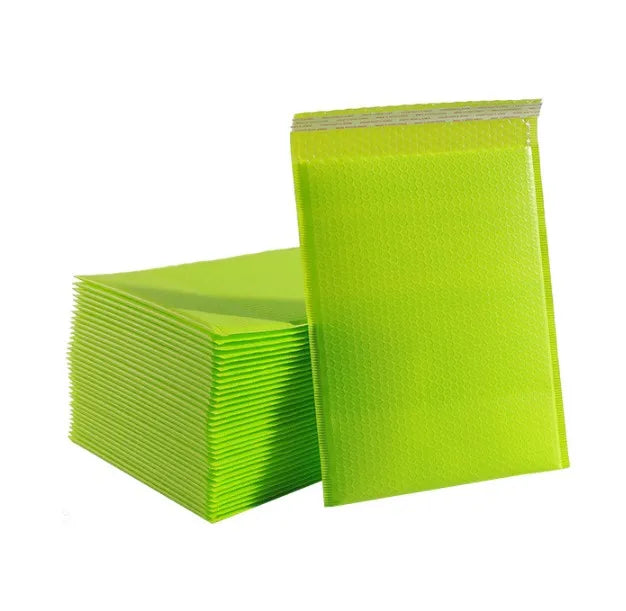 Stack of green poly shipping bags with self-seal top and smooth outer surface
